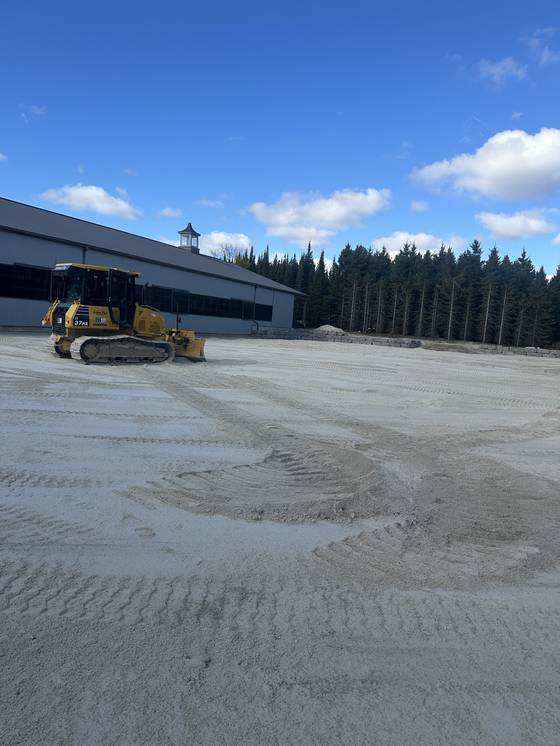 Graded gravel lot at large building