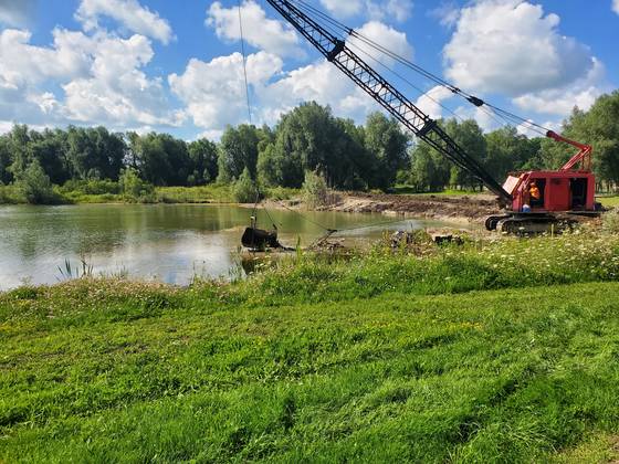 Dragline crane dredging a pond