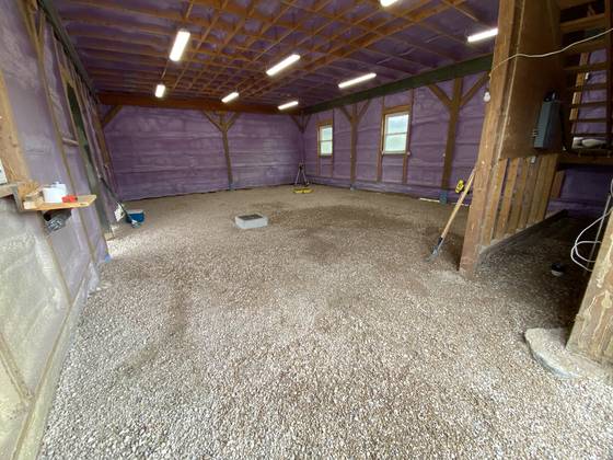 Graded gravel floor in a barn
