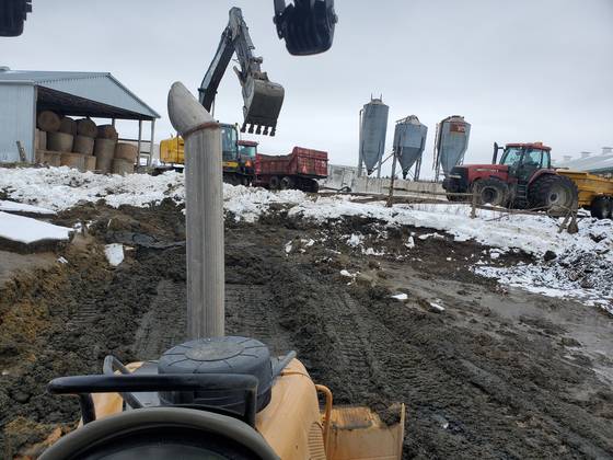 Excavator at a farm in winter